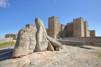 Castle and historic city fortification with rocks and towers