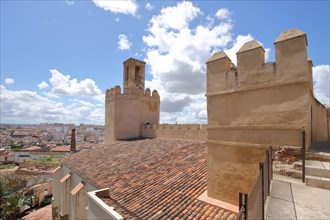 Roofs and historic tower Torre de Espantaperros of the city fortification Alcazaba