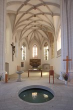 Interior view with baptismal font in the floor of St. Petri Pauli Church and Luther's baptistery