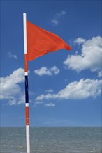 Red warning flag signalling high hazard. Swimming discouraged