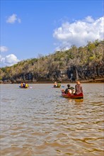 Tourists sitting in boats on the Tsiribina river
