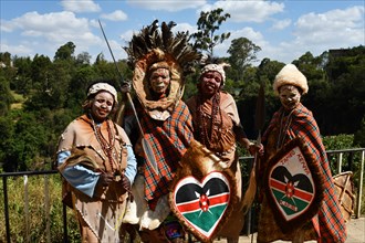 Kikuyu dancer with face paint poses for photographers at Nyahururu Falls