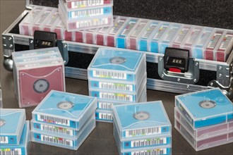 Data backup magnetic tapes lie next to a lockable transport case