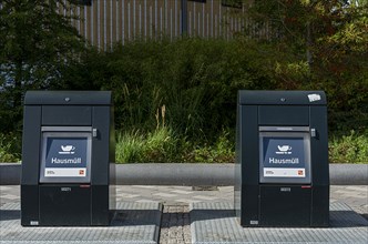 Modern household waste containers in front of new buildings in Europacity