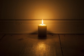 Candle on wooden floor