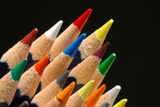 Close-up of crayons against a black background