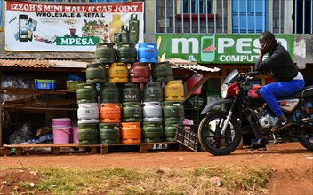 Motorcyclists at a service station for gas cylinders in Kenya