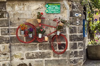 Bicycle and hiking trail signs decorated with flowers for tours