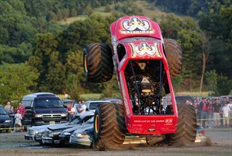 Monster Truck Riding Over Parked Cars