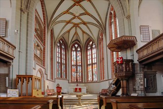 Interior view with pulpit and chancel of the Gothic town church