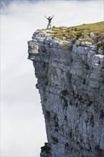 Man standing on the edge of the Creux du Van