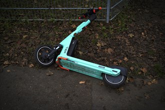 E-scooter lying on the side of the road in the bike rental of the company TIER