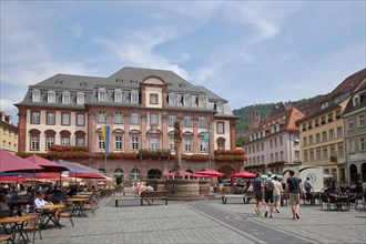 Town hall at the market place with street pub and people in Heidelberg