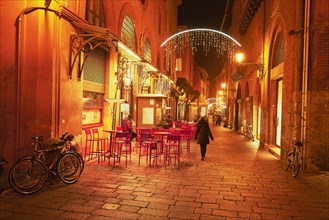 Street cafe in the pedestrian zone with Christmas lights