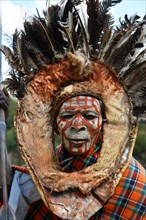 Kikuyu warrior with face paint poses for photographers at Nyahururu Falls