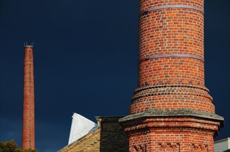 Factory chimney in front of storm clouds