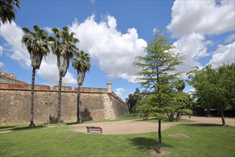 Historical fortification Baluarte de la Trinidad and park with palm trees
