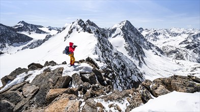 Ski tourer taking photos at the ridge