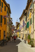 Brown and white flags in the pedestrian zone of San Quirico dOrcia