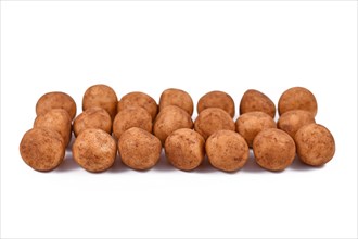 Traditional German Christmas sweets called Marzipankartoffeln in shape of round balls made of almond paste pieces covered in cinnamon and cocoa powder isolated on white background