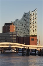 Ueberseebruecke and Elbe Philharmonic Hall in the evening light in the wintry harbour of Hamburg