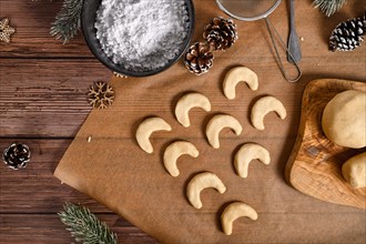Baking traditional German or Austrian crescent shaped christmas cookies called 'Vanillekipferl'