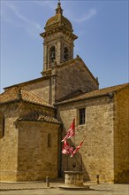 Red and white flags at the Romanesque Collegiate Church