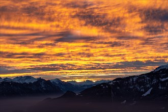 Burning sky in front of sunrise over the Swiss Alps