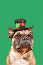 French Bulldog with snowman top hat in front of green background