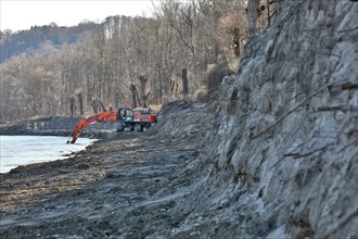 Excavator on a removed river bank