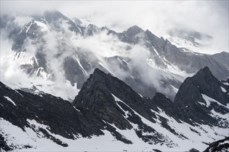 Mountains in winter with clouds and fog