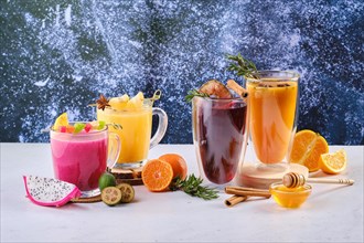 Assortment of hot winter drinks with fruits and aromatic herbs