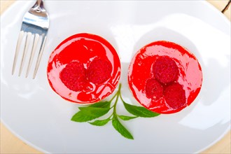 Fresh raspberry cake mousse dessert round shape with mint leaves