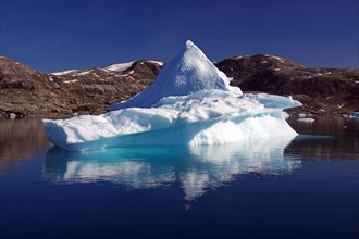 Iceberg reflected in a fjord