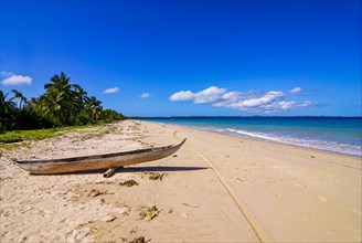 Canoe on a white sand beach on the Island Ile Sainte-Marie although Nosy Boraha
