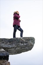 Woman standing on stone in icy cold