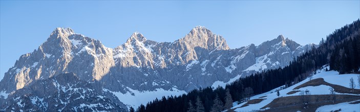 Blue sky above snowy alpine peak