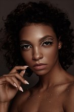Beautiful African American woman with trendy makeup
