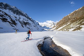 Ski tourers in the Oberbergtal valley on the Oberbergbach stream