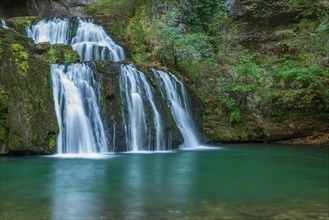 Waterfall from the source of the Lison in a haven of tranquillity with its waterfall surrounded by woods. Nans-sous-Sainte-Anne