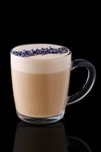 Cup of cappuccino with lavender flavour on black background