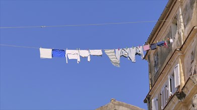 Clothesline with laundry hanging high above Old Town alley