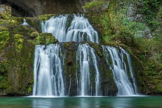 Waterfall from the source of the Lison in a haven of tranquillity with its waterfall surrounded by woods. Nans-sous-Sainte-Anne