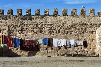 Laundry hanging to dry on a line in front of the city wall
