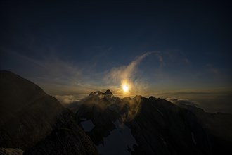 Altmann summit with yellow cloud wisps at sunrise