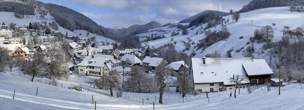Village panorama with church in winter