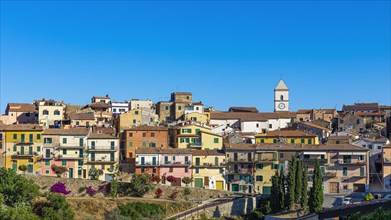 The mountain village of Capoliveri with pastel-coloured house facades against a blue sky