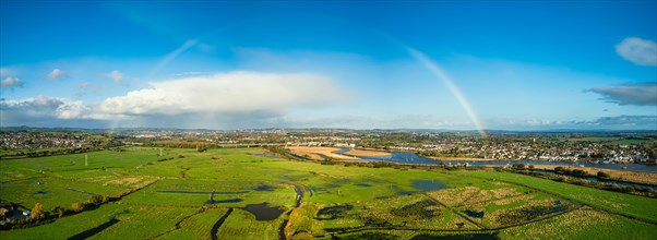 Rainbow at Sunrise over RSPB Exminster and Powderham Marshes from a drone in panorama