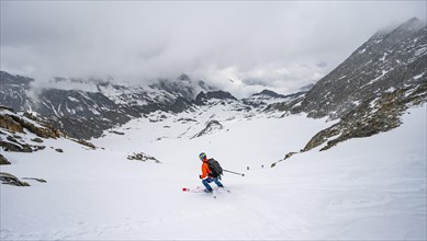 Skiers skiing downhill on the Sommerwandferner glacier