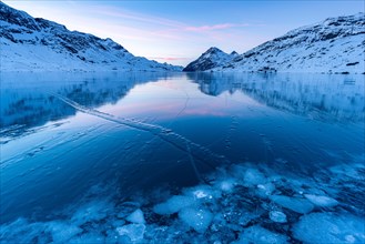 Ice structures in the black ice of the frozen Lago Bianco in the Swiss mountains in the evening light